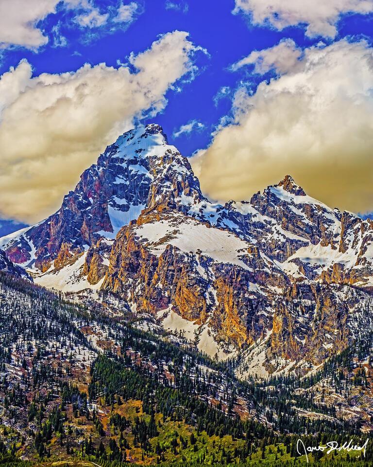Grand Teton and Mount Owen rise up sharply from the floor of Jackson Hole Valley like an American Matterhorn as sunlight illuminates the snow on the steep faces