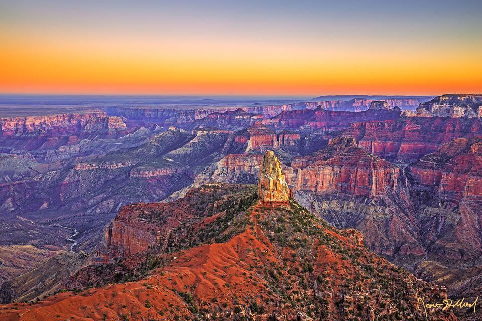 Sunset illuminates the skies above Mount Hayden, Alsap Butte, Colter Butte, Ehrenberg Point, and Nankoweap Creek along the North Rim of the Grand Canyon.