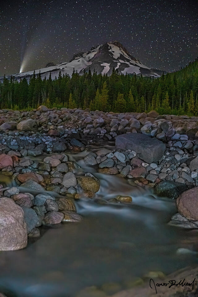 Comet NEOWISE (C/2020 F3) begins to disappear behind Mount Hood and the White River as it flows down from the White River Glacier up on the mountain.