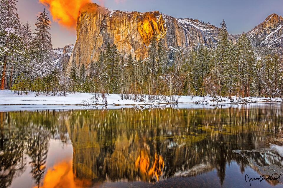 Sunset lights El Capitan orange from the last bit of sun as the waters of Horsetail Fall glow orange like lava as the famous Yosemite Firefall comes to life.