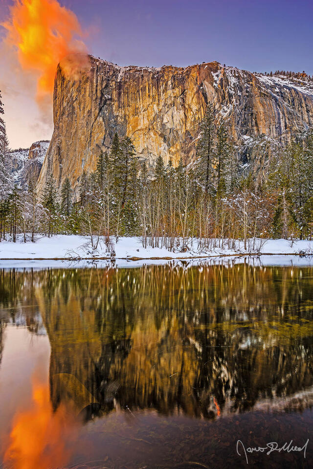 Sunset colors the sky above El Capitan & the Merced River, as the waters of Horsetail Falls glow orange like lava as the famous Yosemite Firefall comes to life.