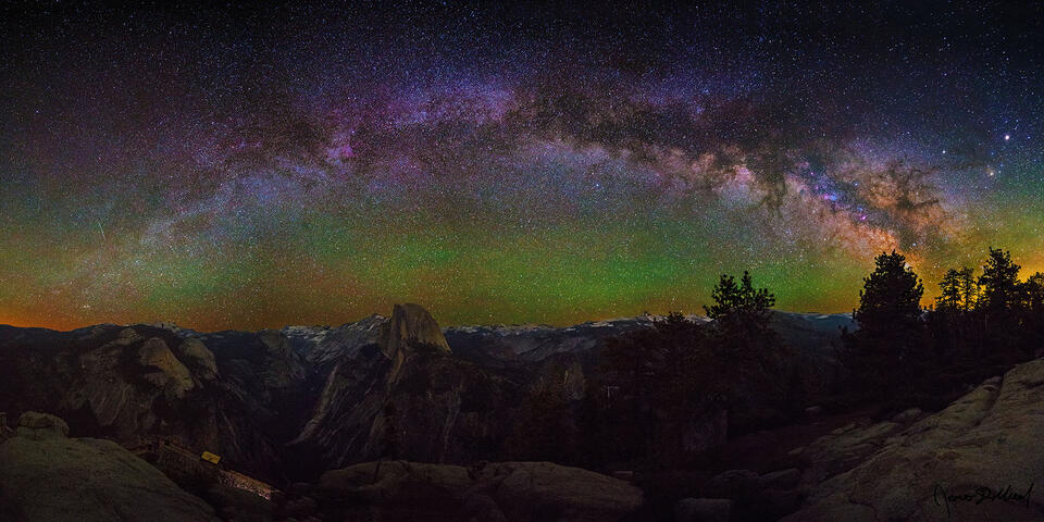 The Milky Way Arch rises high into the night sky over Half Dome, North Dome, Basket Dome, Clouds Rest, Mount Watkins and the Yosemite High Country
