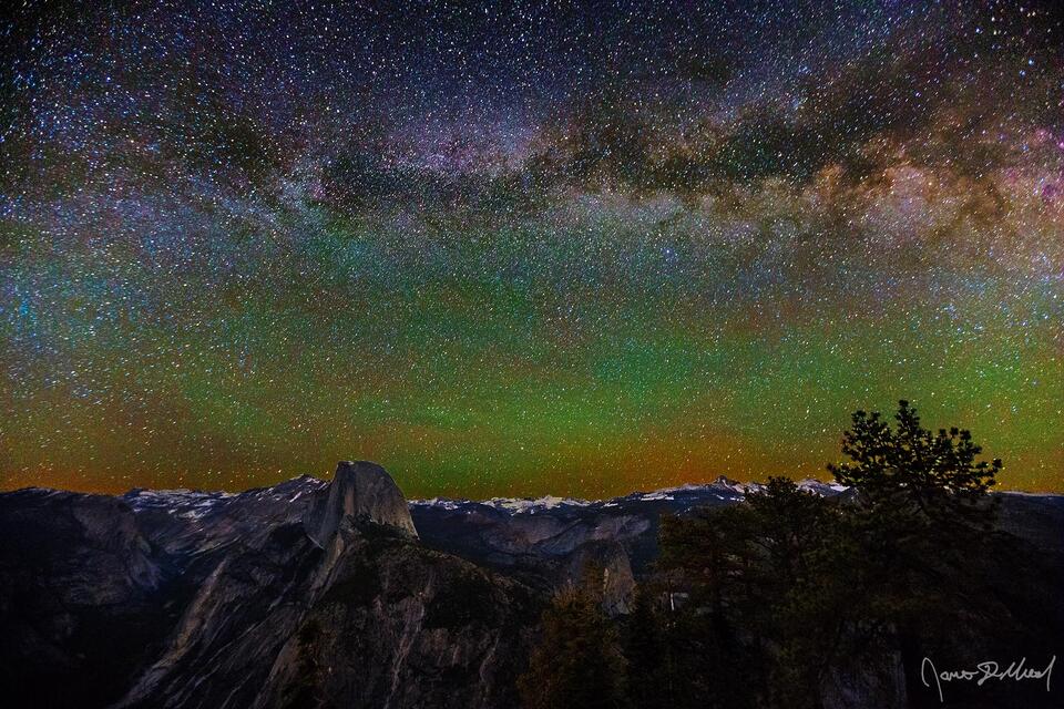 The Milky Way stretches across the night sky above Half Dome, Quarter Domes, Mount Watkins, Tenaya Peak and the Yosemite High Country