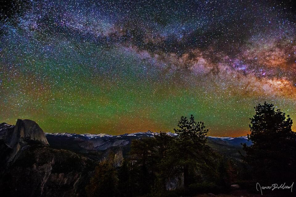 The Milky Way stretches across the sky above Half Dome, Kuna Crest, Fletcher Peak, Vogelsang Peak, Little Yosemite Valley, Cloud's Rest and the Diving Board.