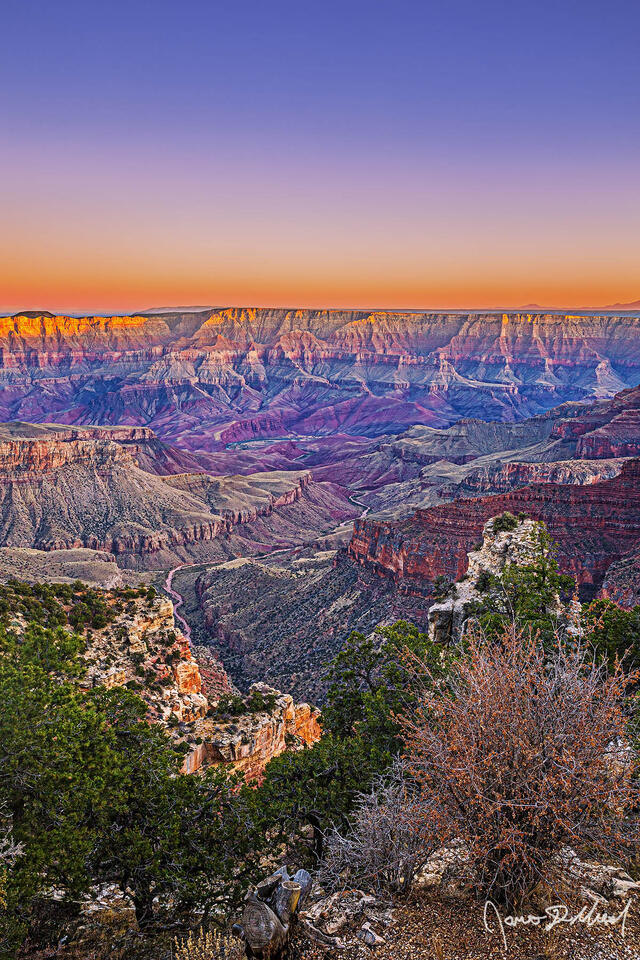 Sunset glow on the Palisades of the Desert and the South Rim as pastel colors show in the skies above the Grand Canyon, Unkar Creek and the Colorado River.