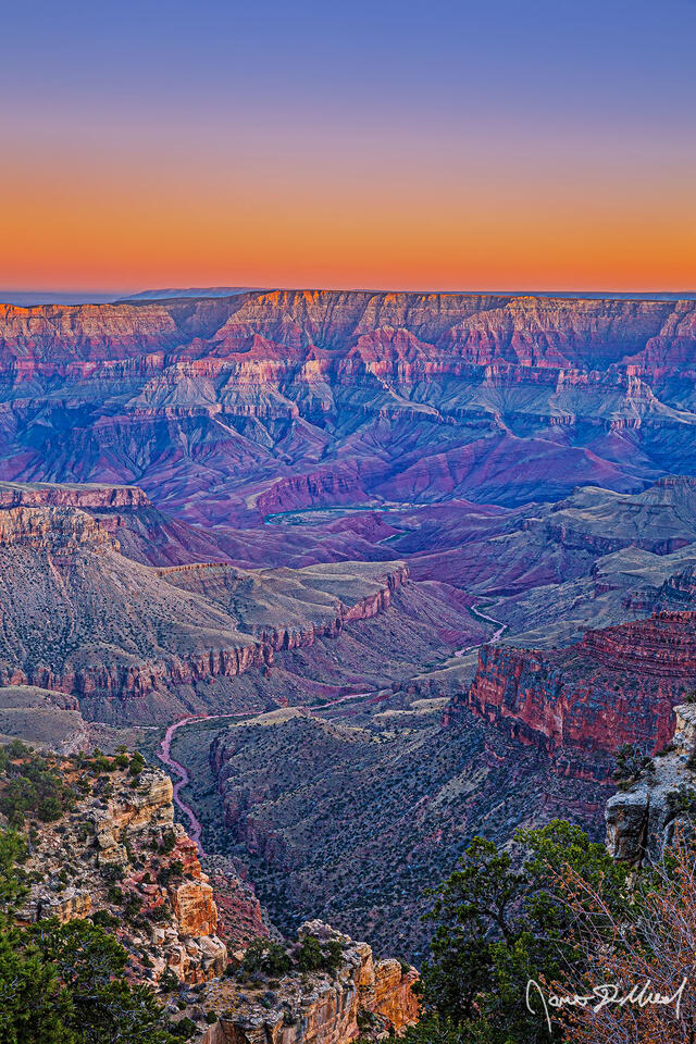 Pastel colors at sunset show in the skies above the Palisades of the Desert, Unkar Creek and the Colorado River as light glows on the east rim and south rim.