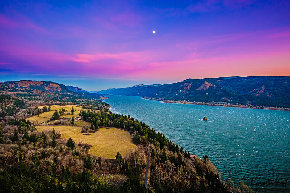 Sunset of the year brings the pastel colors of the Belt of Venus to the skies above the Columbia River as the moon rises into the evening sky.
