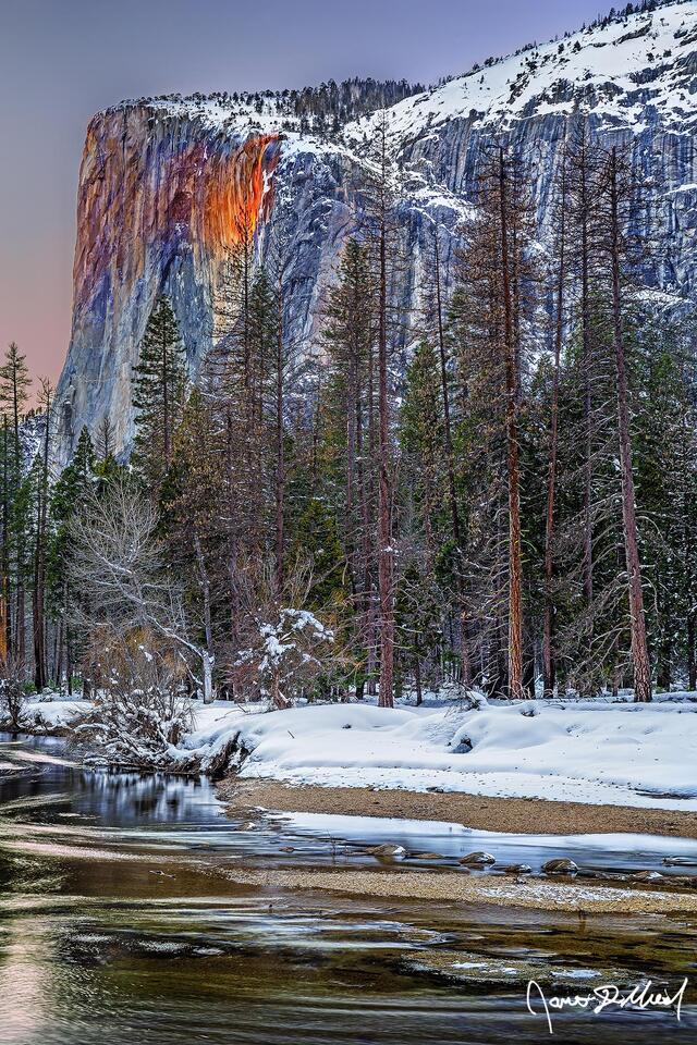 Sunset colors the sky above El Capitan & the Merced River, as the waters of Horsetail Falls glow orange like lava as the famous Yosemite Firefall comes to life.