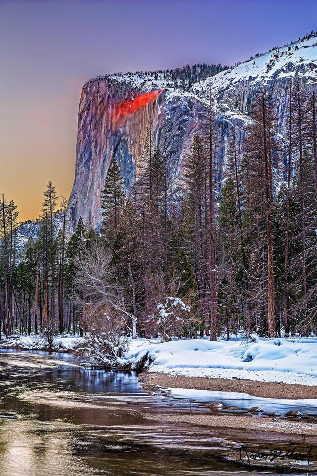 Sunset lights the sky, the waters of Horsetail Falls on El Capitan glow a deep orange like lava. Wind kicks up glowing mist a Yosemite’s Firefall comes to life.