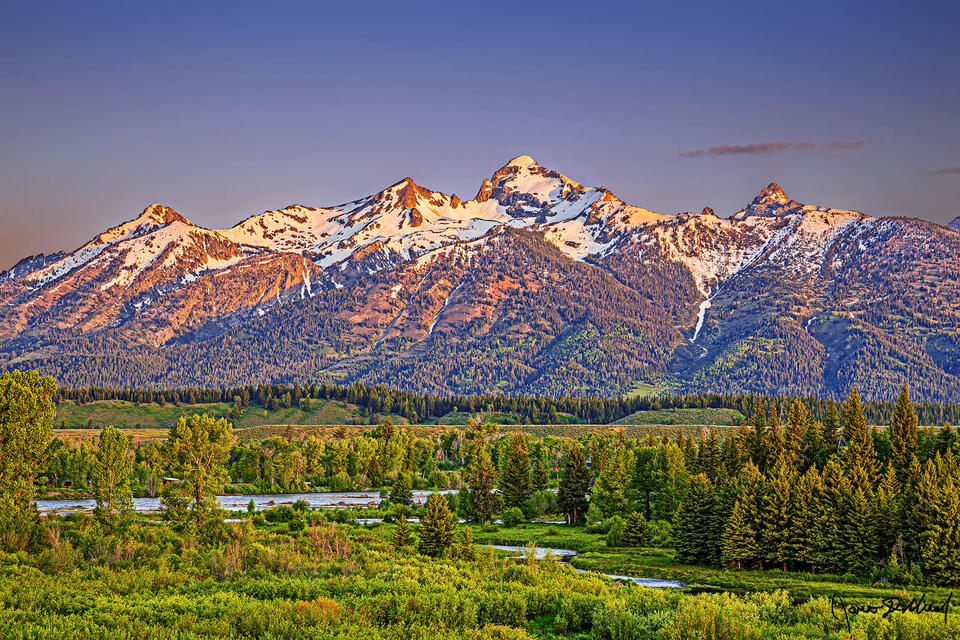 Sunrise illuminates Albright Peak, Static Peak, Buck Mountain, Veiled Peak and Mount Wister as they rise above a wetland meadow and the Snake River
