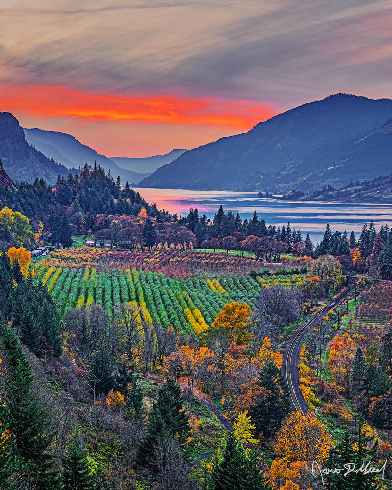 Autumn Sunset over the Columbia River, Columbia River Gorge, Oregon. Sunset lights the skies above as Autumn Colors dot the landscape along the Columbia River.