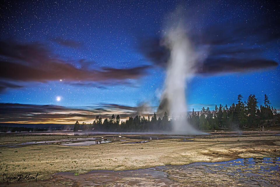 Venus and Pollux shine in the skies over Lower Geyser Basin in Yellowstone as steam rises up from Celestine Pool as Fountain Geyser.