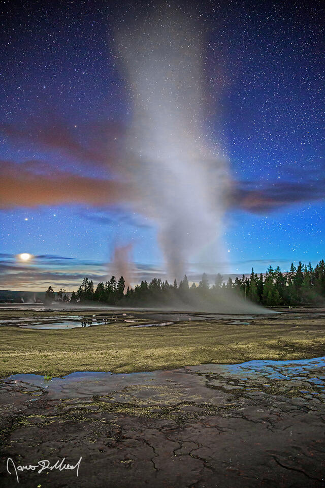 Venus sets over Lower Geyser Basin in Yellowstone during astronomical twilight as Pollux shines above steam rises up from Celestine Pool as Fountain Geyser.