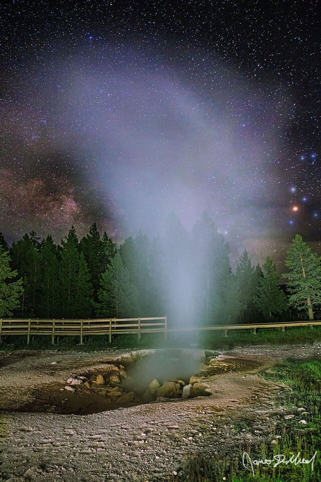 Steam rises from Red Spouter in Yellowstone National Park's Lower Geyser Basin as the Milky Way begins to rise in the night sky above.