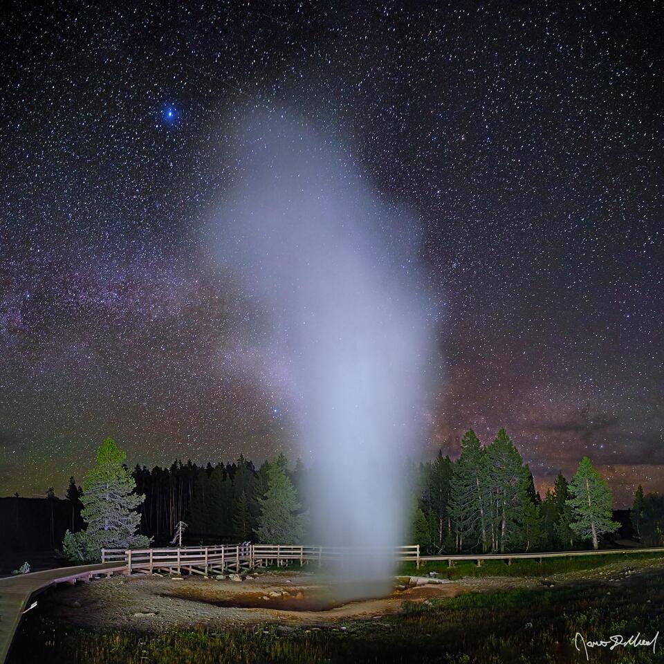 Steam rises from Red Spouter in Yellowstone National Park's Lower Geyser Basin as the Milky Way begins to rise in the night sky above.