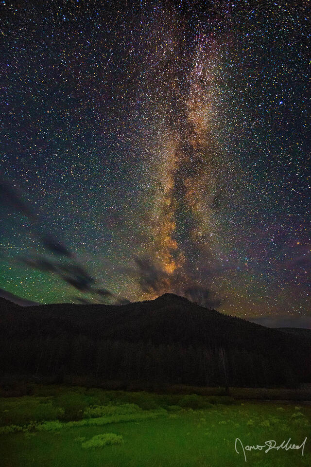 The Milky Way core rises into the sky above Monument Montana in Yellowstone National Park.
