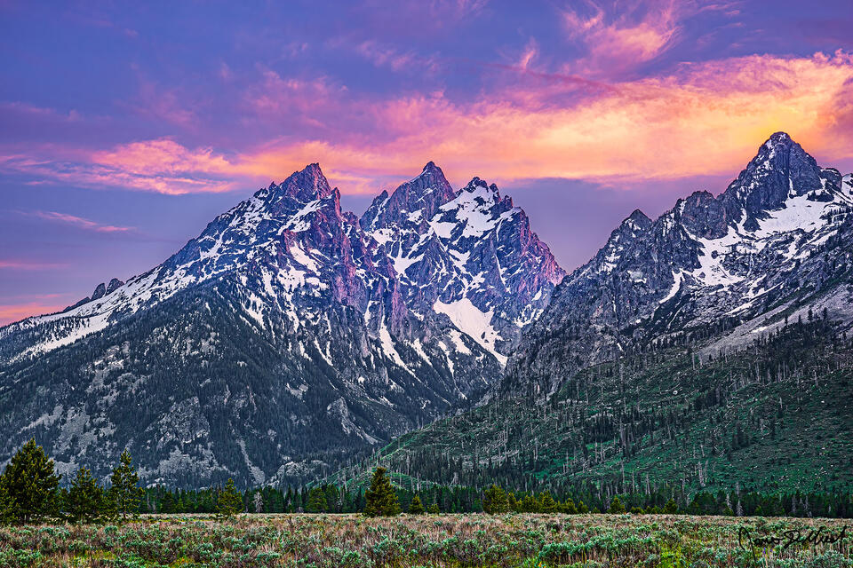 Alpenglow shines through Cascade Canyon at sunset and illuminates the northern faces of the Cathedral Group.
