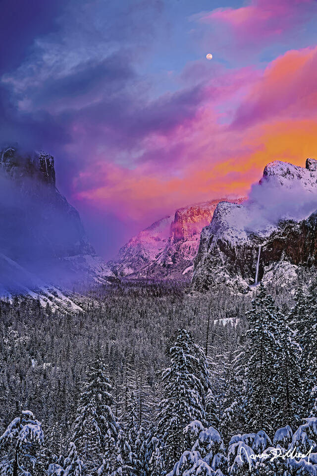 Full Moon rises as alpenglow lights snow covered Cathedral Rocks. Fog cloaks El Capitan, glowing a faint hue as Bridelveil Fall tumbles towards the snowy valley