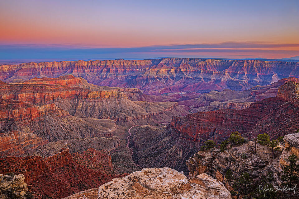 Pastel colors light the Grand Canyon, Unkar Creek and the Colorado River illuminating Venus Temple, Apollo Temple and the the Palisades of the Desert.