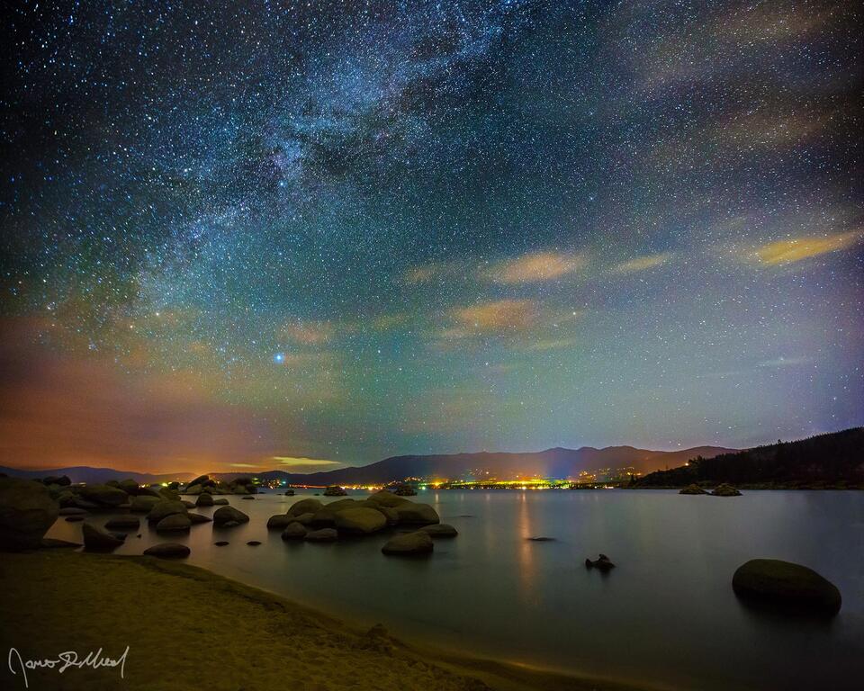 The Milky Way rises above the clouds on the Horizon and into the night sky high above the shores of Sand Harbor on Lake Tahoe.