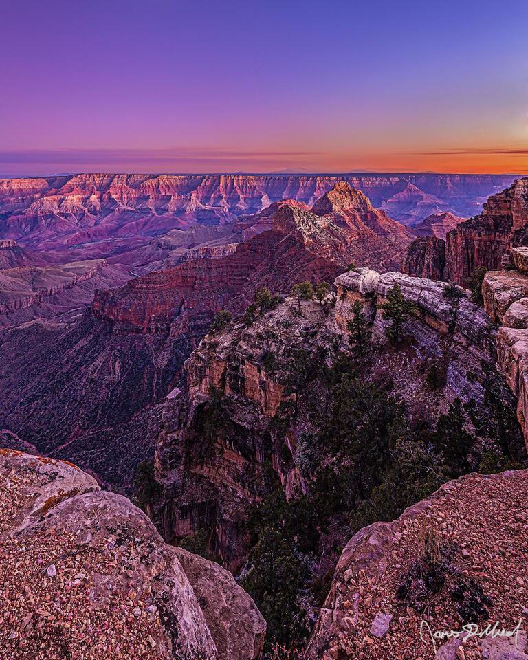 Alpenglow illuminates the skies over the Grand Canyon, Freya Castle, Vishnu Temple, Unkar Creek and the Colorado River illuminating the Palisades of the Desert.