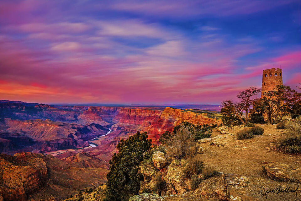 Alpenglow lights the skies above Desert View Watchtower at the edge of the Grand Canyon as the last colors of the sunset hang on at dusk.