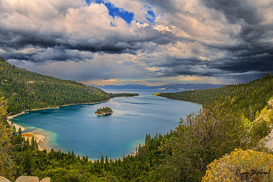 Storm clouds rolls in from the south, covering the skies above Lake Tahoe and Emerald Bay as a summer rain storm begins over South Lake Tahoe.