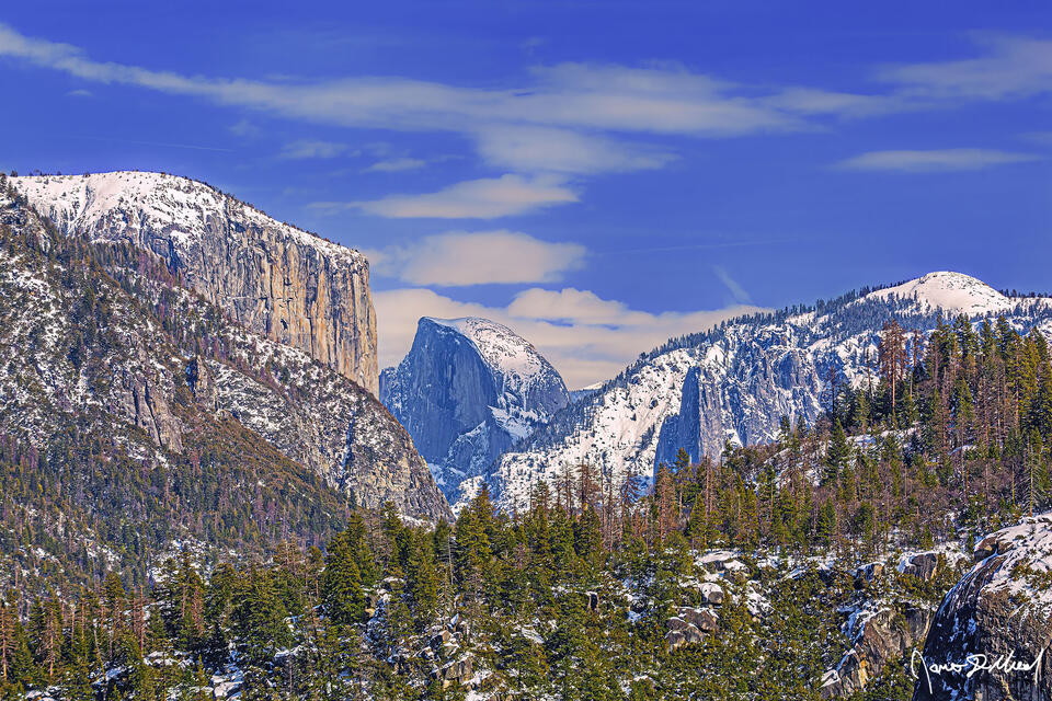 Snow blankets the tops of El Capitan, Half Dome, Sentinel Dome and the cliffs of Yosemite in the winter.