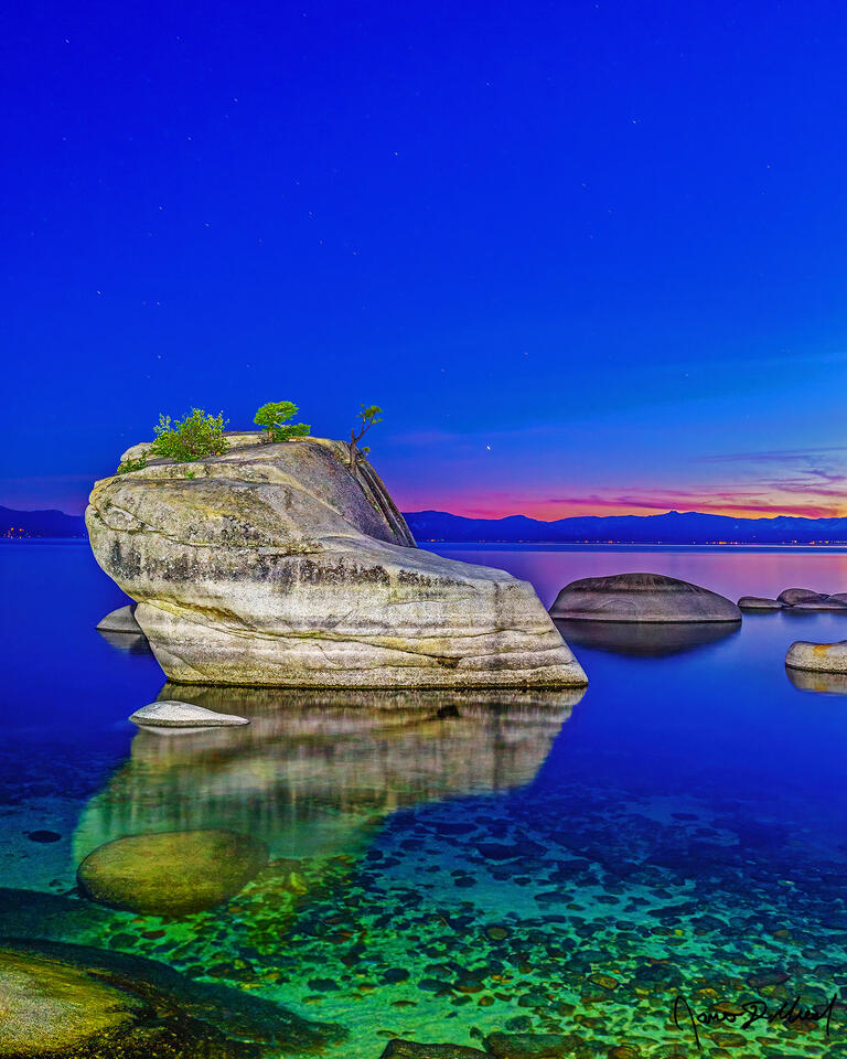 Slight alpenglow illuminates the horizon over Bonsai Rock and Lake Tahoe at nautical dusk, as the last colors of daylight fade away.