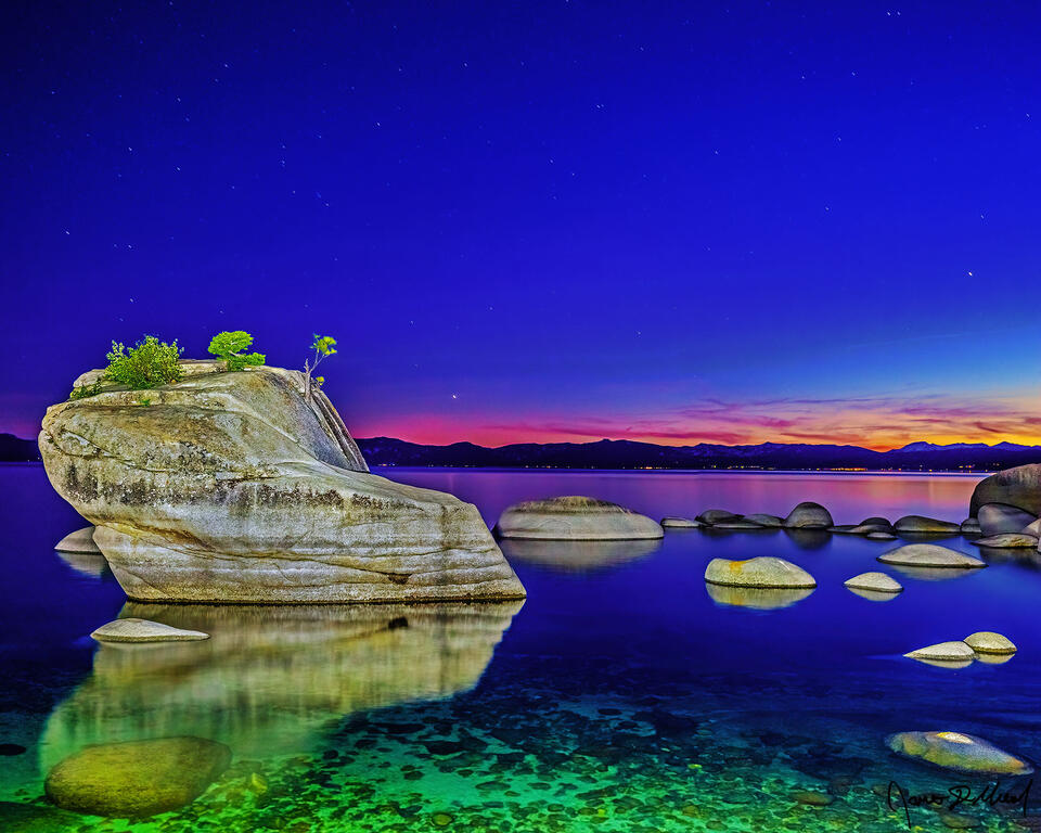 Slight alpenglow illuminates the horizon over Bonsai Rock and Lake Tahoe at nautical dusk, as the last colors of daylight fade away.