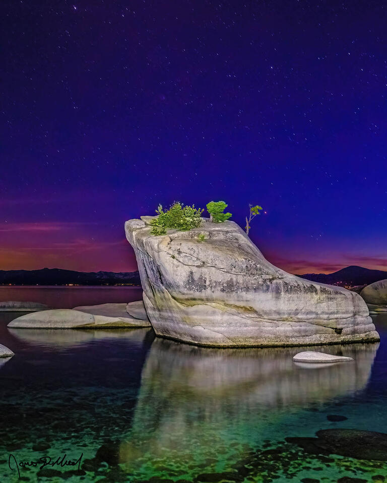 The last colors of the long set sun hang on along the horizon, as the stars announce the arrival of astronomical twilight above Lake Tahoe and Bonsai Rock.