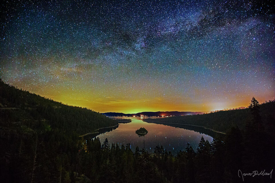 The Milky Way stretches high across the sky over the waters of Emerald Bay and Lake Tahoe in California.