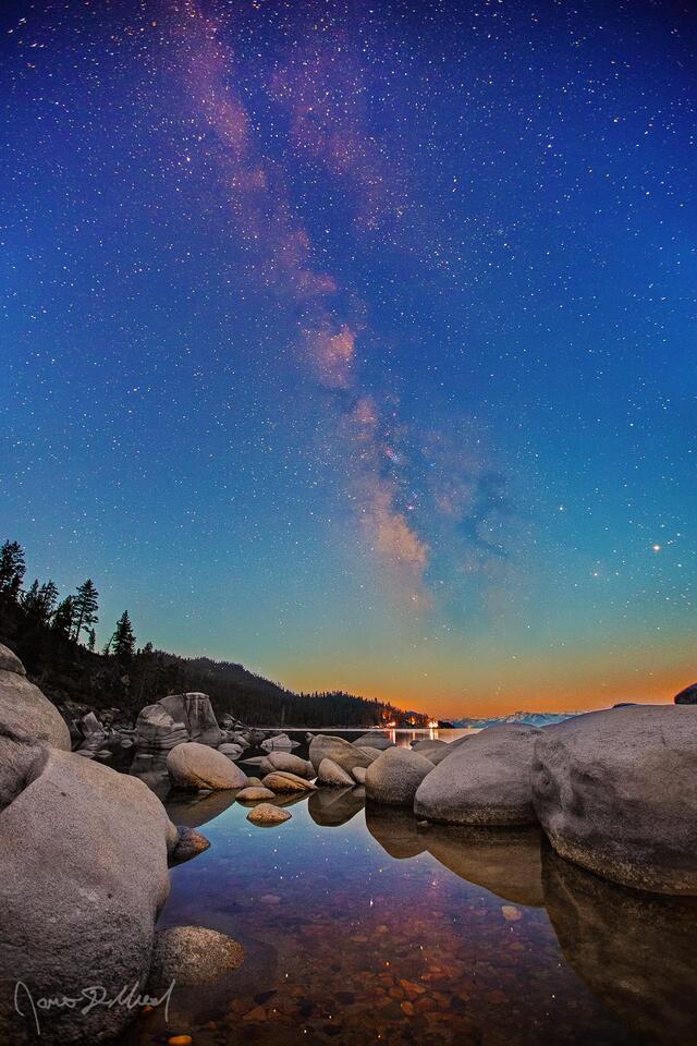 The Milky Way rises high into the night skies over Lake Tahoe and Bonsai Rock as Nautical Sunrise sets in.