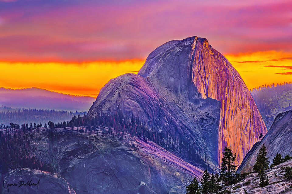 Sunset bathes skies above in brilliant light as alpenglow illuminates Half Dome and the Yosemite High Country of Yosemite National Park near Olmstead Point.