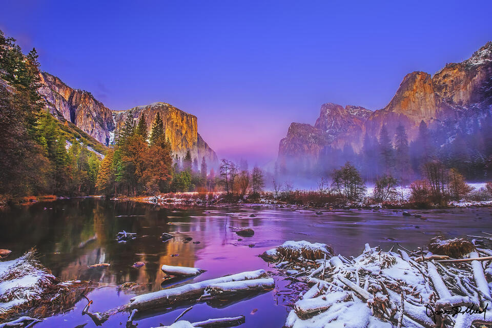 Yosemite Valley, El Capitan and Cathedral Rocks glow at sunset in the winter. Pink alpenglow illuminates the sky and reflections in the Merced River.