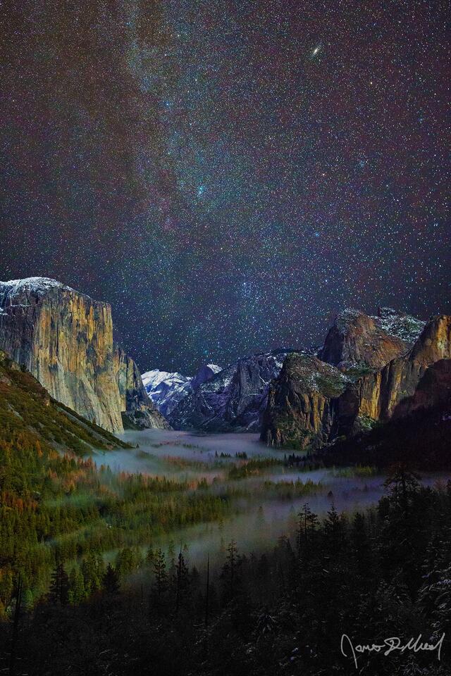 The fog of night rolls into Yosemite Valley as the Andromeda Galaxy and the winter Milky Way rise up into the sky above Bridalveil Fall and Tunnel View.