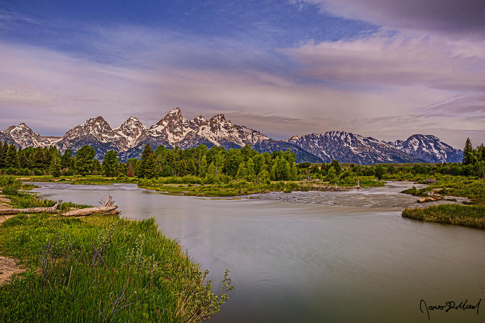 Morning Light illuminates the Cathedral Group as branches of the Snake River merge together.