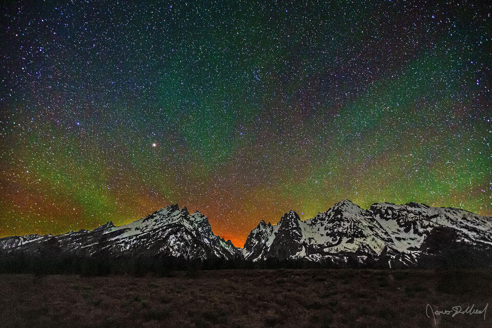 The skies above the Cascade Canyon and the Teton Range dance with light at night as airglow slowly moves across the sky.