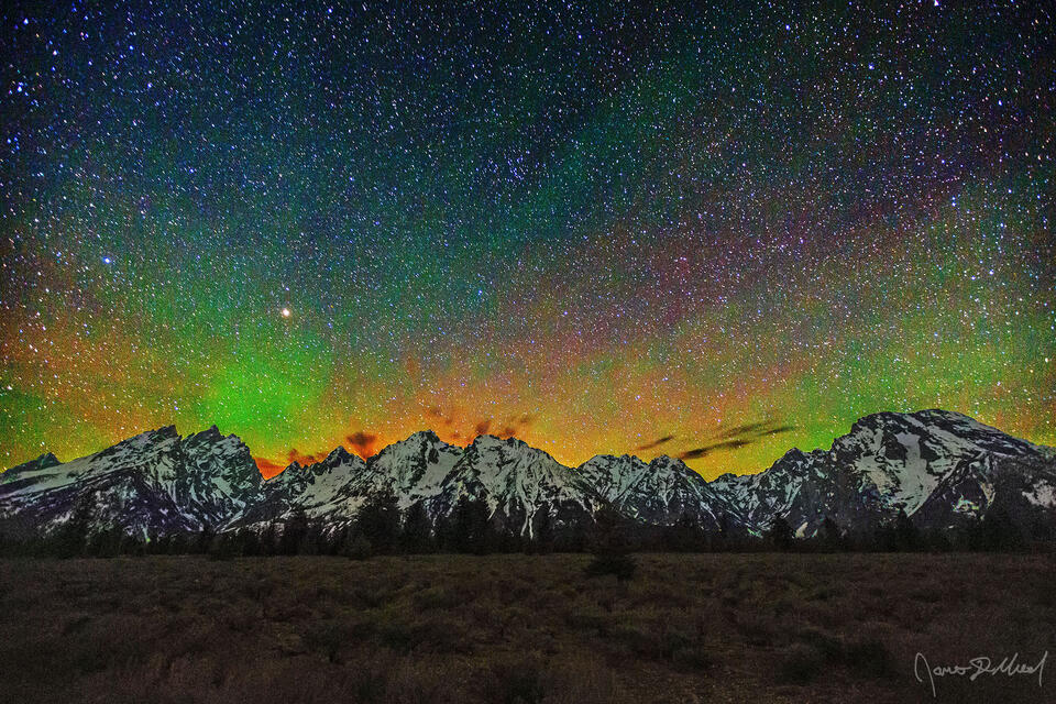 The skies above the Teton Range dance with light at night as airglow slowly moves across the sky.