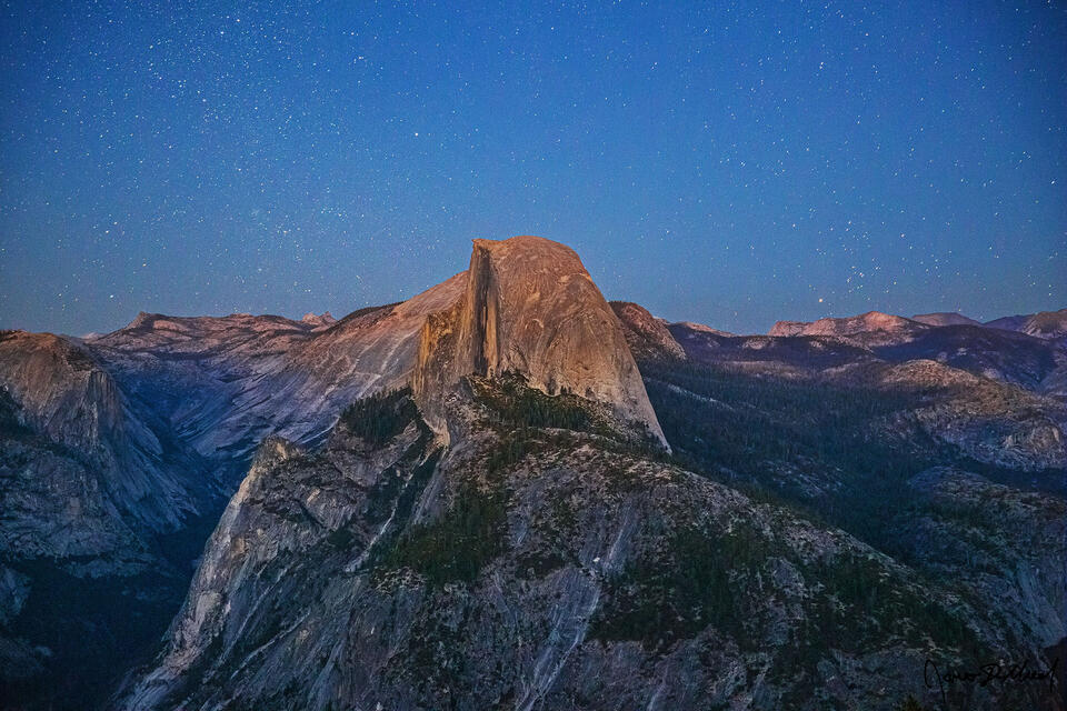 The stars begin to come out in the sky as Nautical Dusk sets in over Half Dome, Clouds Rest, Mount Waktins and Tenaya Canyon.