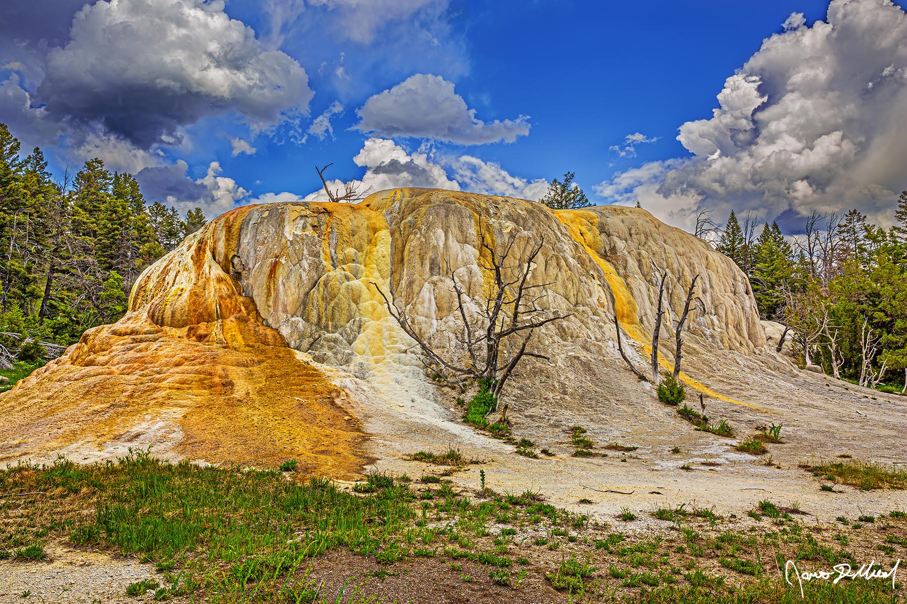 Gold Slide Storm clouds roll in over Orange Spring Mound near near Mammoth Hot Springs in Yellowstone National Park as the skies begin to darken.
