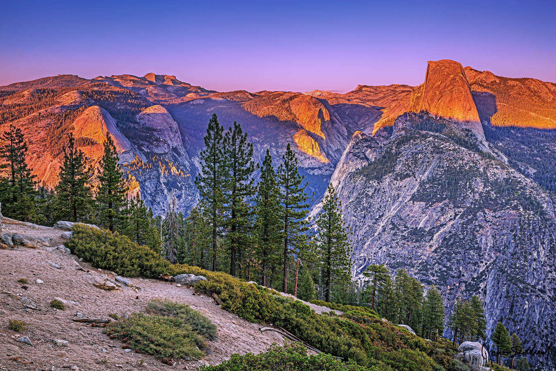 Over the Range Alpenglow at Sunset illuminates Half Dome, Mount Watkins, Clouds Rest, North Dome and Basket Dome as soft pastel colors of the Belt of Venus lights the skies.