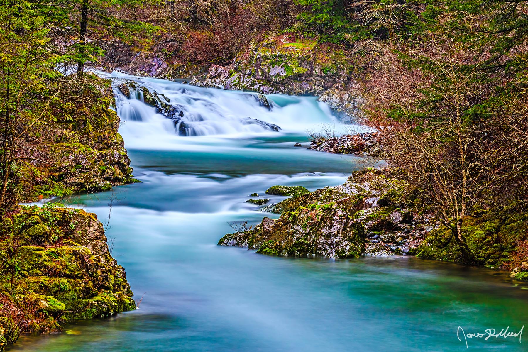 Emerald Path Turquoise glacial water cascades 17 feet over a sloping ledge along the Washougal River on as it makes its way downstream towards the Columbia River.