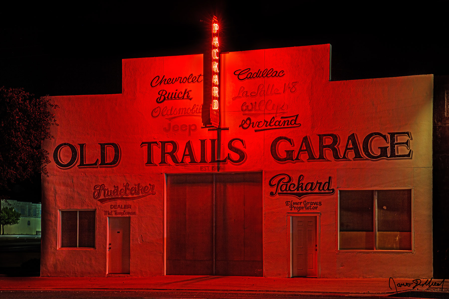 Neon Dream Old Trails Garage, Route 66, Kingman, Arizona Red neon signage illuminates the front of historic Old Trails Garage on...
