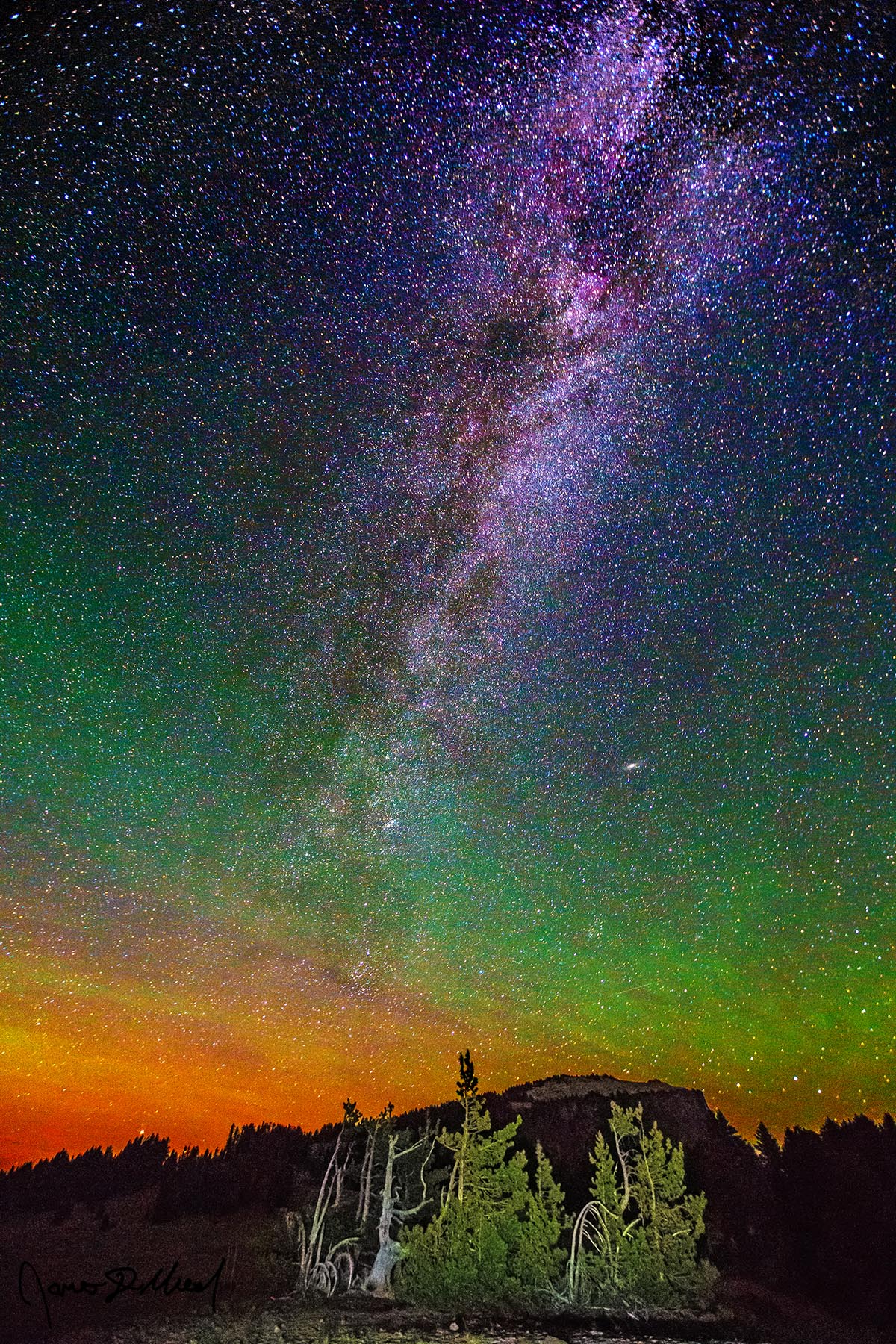 Llao's Starlight - Milky Way, Rainbow Airglow and Andromeda Galaxy over Llao Rock at Crater Lake Green airglow and the spiral arm of the Milky Way light up the skies above Llao Rock in Crater Lake National Park.