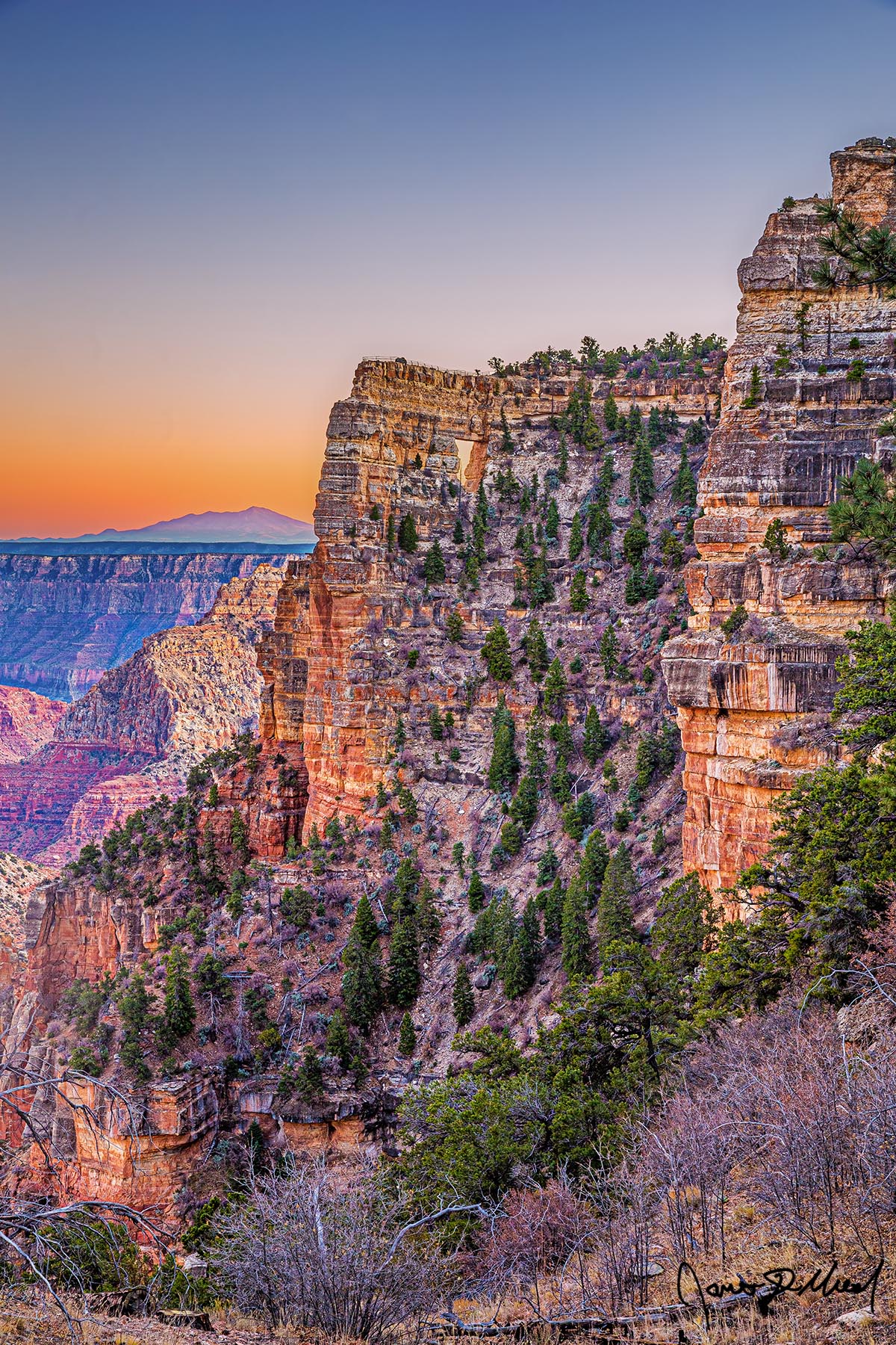 Magic Window - Sunset over Angels Window, Vishnu Temple, the Grand Canyon and San Francisco Peaks Sunset brings color to the skies above Angels Window, the Palisades of the Desert and Vishnu Temple in Grand Canyon National Park as San Francisco Peaks rise up