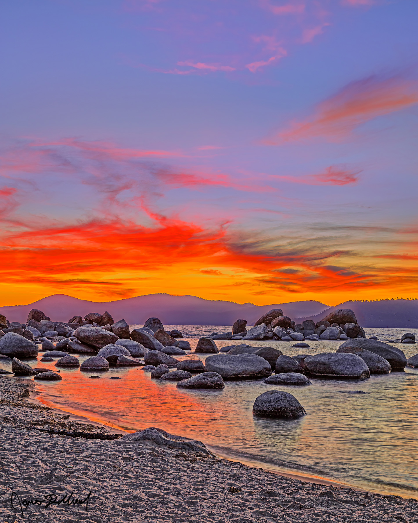 Painted Sunset - Fiery Sunset above Lake Tahoe and Granite Boulders at Sand Harbor Beach Fiery oranges and reds mix with soft pastels at sunset, bathing the sky in an spectacular display of colors Sand Harbor and Lake Tahoe.