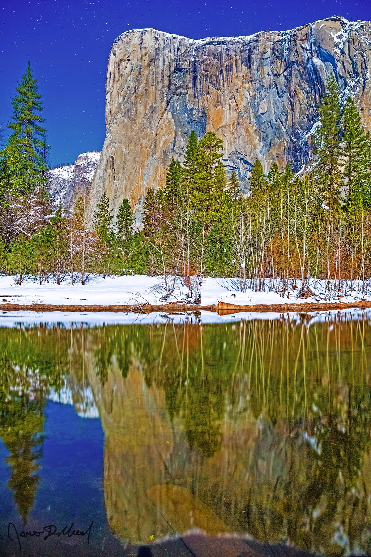 Reflection Paradise A full Moon illuminates the El Capitan as it reflects in the Merced River at in the dead of winter. Fresh snowfall glows in the moonlight as it lines the river.