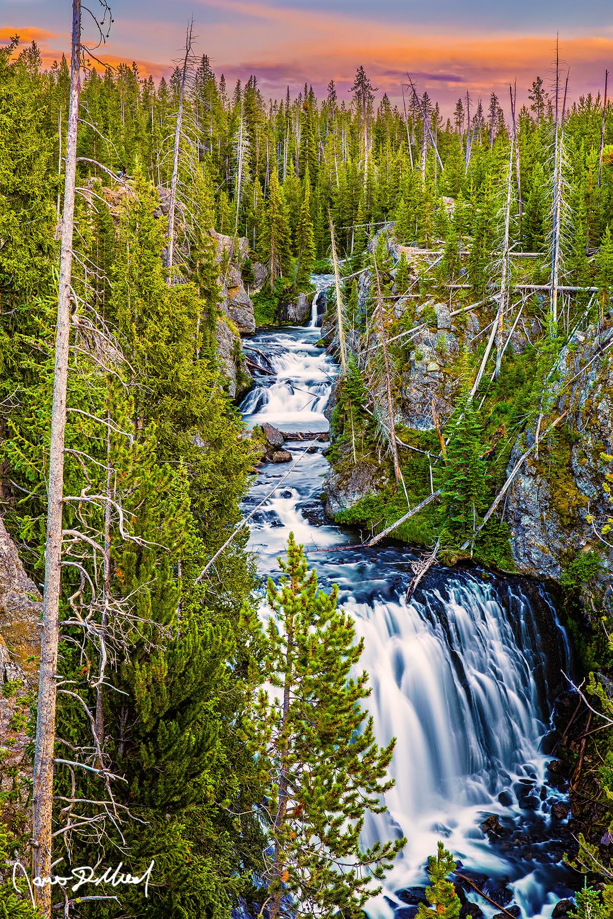 Cascading Wonders Kepler Cascades on the Firehole River drops 50 feet at sunset as it rushes into a narrow gorge below in Yellowstone National Park.