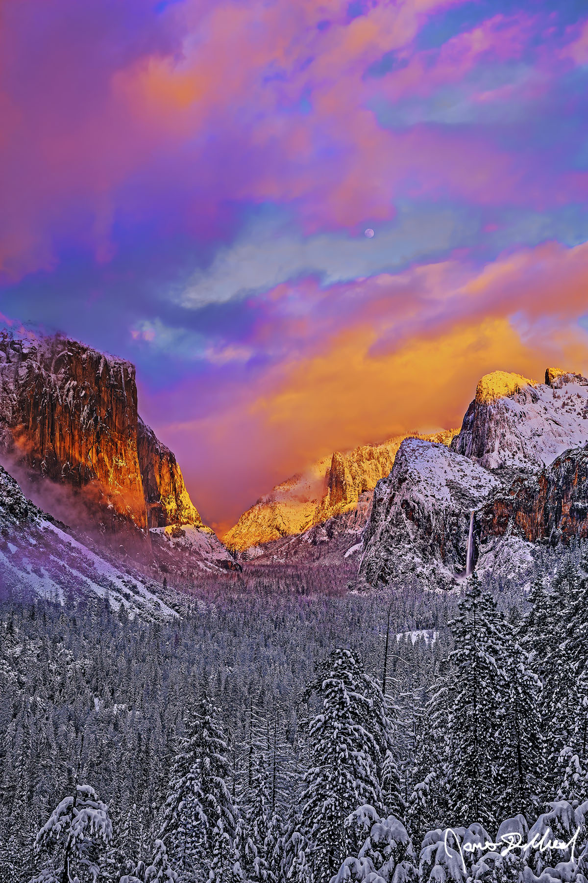 Brilliance The full Moon rises at sunset above the snow covered walls of Yosemite Valley, as fog begins to cloak the lower portions of El Capitan as Bridalveil Fall flows.